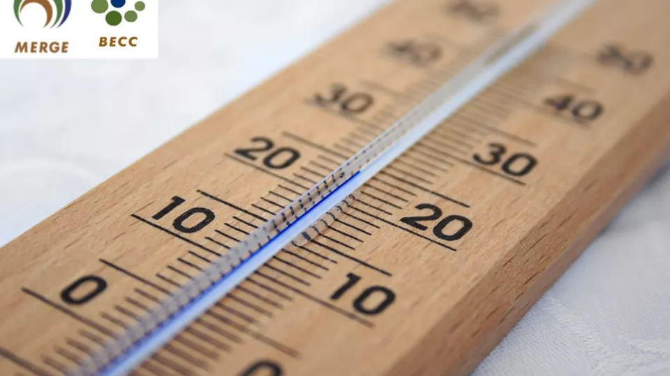 A wooden thermometer reaching 20degree with a blue line. BECC and MERGE logos in the upper left corner. Photo with attached logos.
