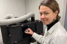 Researcher Milda Pucetaite puts a transparent soil chip with fungi hyphae