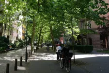 Bild på cyklister i en grönskande stadsmiljö