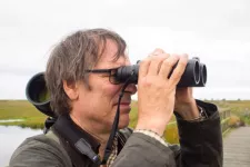Henrik Smith looks into his binoculars